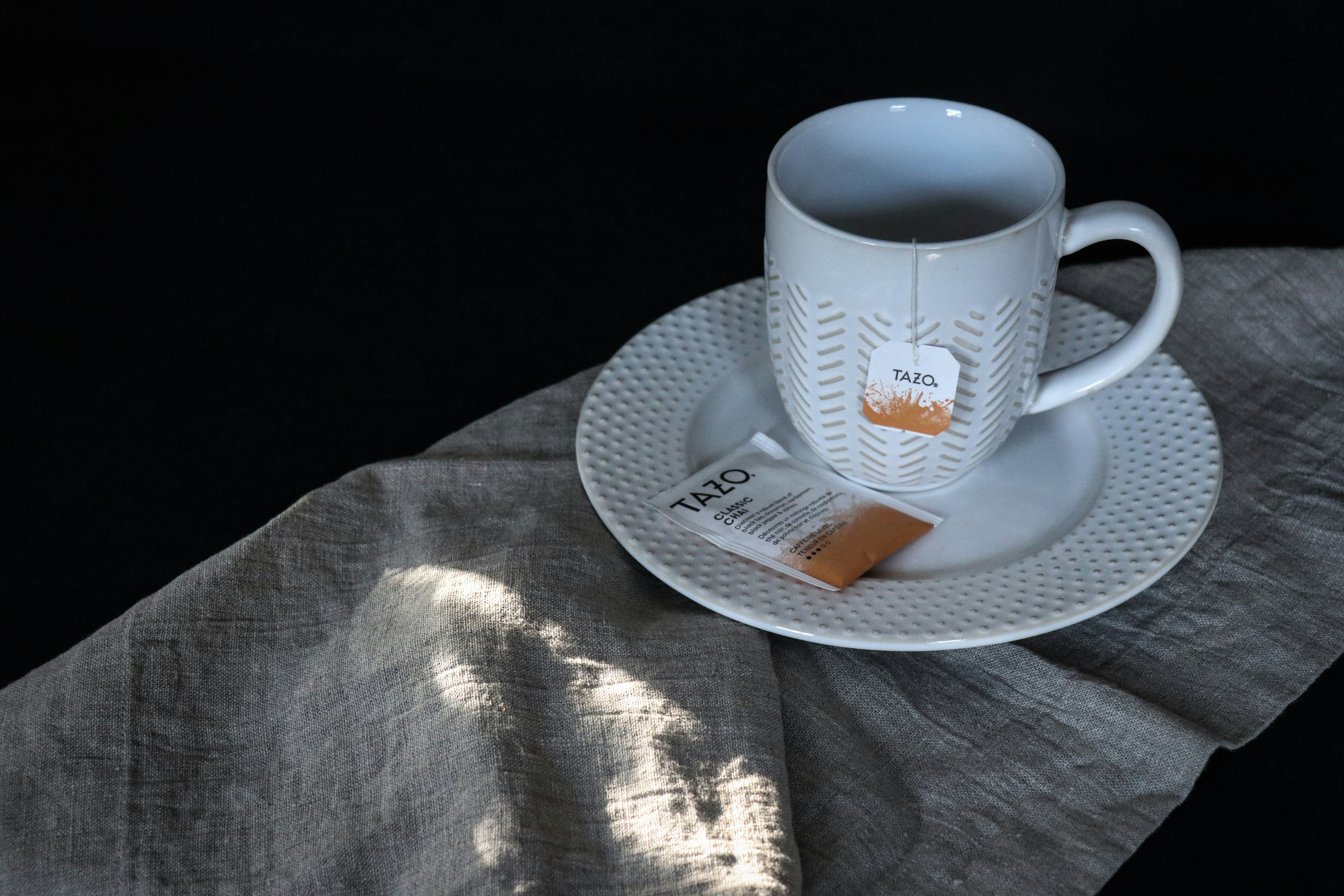 white ceramic mug on white ceramic plate